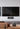Wall-mounted TV with KEF speakers in a cozy living room setup at Olson's Hi-FI, Lynnwood, WA